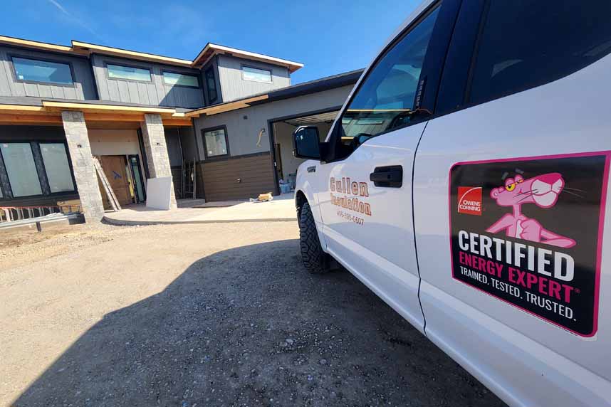 Cullen Information truck with Pink Panther "Certified Energy Expert" logo parked outside a modern house under construction.