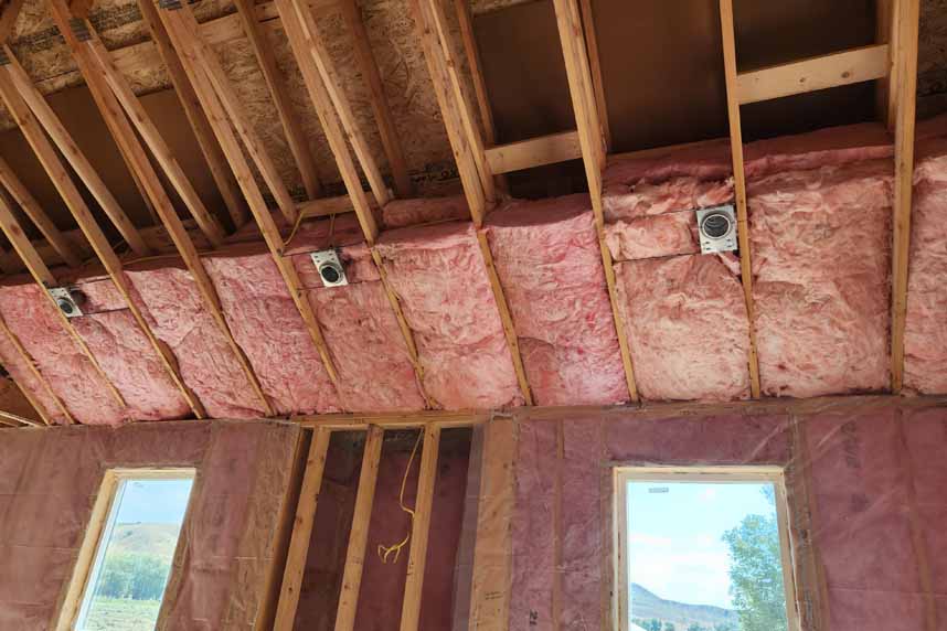 cullen-fiberglass-batts-wall-and-ceiling Insulation batts installed in ceiling and walls of a wooden structure