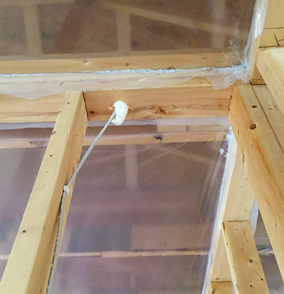 Cullen Insulation air sealing and vapor barrier installation at ceiling joists in Fargo, ND.